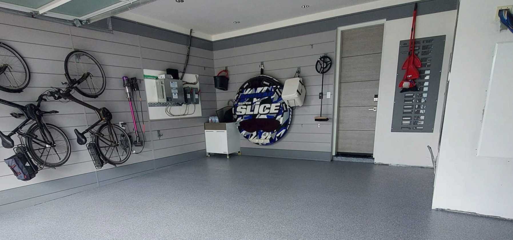 Garage wall organized with slatwall panels and accessories